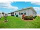 Landscaped backyard with lush green lawn and decorative shrubbery and trees at 7323 Steer Blade Dr, Zephyrhills, FL 33541
