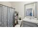 Full bathroom with shower, decorative curtain, modern vanity, and a decorative mirror at 7323 Steer Blade Dr, Zephyrhills, FL 33541