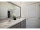 Bathroom featuring double sinks, a large mirror, and modern fixtures at 7323 Steer Blade Dr, Zephyrhills, FL 33541