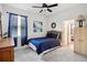 Stylish bedroom featuring a comfy bed, natural lighting, and calming blue accents at 7323 Steer Blade Dr, Zephyrhills, FL 33541