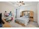 Serene bedroom with tray ceiling, desk area, and a built-in headboard with storage cabinets at 7323 Steer Blade Dr, Zephyrhills, FL 33541