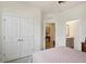 Cozy bedroom showcasing closet space and an en-suite bathroom at 7323 Steer Blade Dr, Zephyrhills, FL 33541