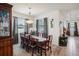 Bright dining room featuring an elegant table set and large windows with stylish curtains at 7323 Steer Blade Dr, Zephyrhills, FL 33541