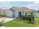 Attractive single-Gathering home with well-maintained lawn, landscape beds, and a three-car garage at 7323 Steer Blade Dr, Zephyrhills, FL 33541