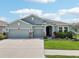 Charming single-story home with well-manicured lawn and three car garage at 7323 Steer Blade Dr, Zephyrhills, FL 33541
