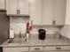 Well-lit kitchen with granite counters, stainless steel sink, and modern appliances at 7323 Steer Blade Dr, Zephyrhills, FL 33541