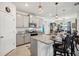 Open kitchen with granite countertops, stainless steel appliances, and island seating at 7323 Steer Blade Dr, Zephyrhills, FL 33541