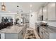 Open kitchen with granite countertops, stainless steel appliances, and a central island at 7323 Steer Blade Dr, Zephyrhills, FL 33541
