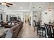 A large living room provides open access to the kitchen and a long hallway at 7323 Steer Blade Dr, Zephyrhills, FL 33541