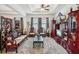 Expansive living room featuring dark wood furnishings, recessed lighting, ceramic tile, and large windows at 7323 Steer Blade Dr, Zephyrhills, FL 33541