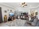 Spacious living room featuring plush seating, tile floors, and stylish decor at 7323 Steer Blade Dr, Zephyrhills, FL 33541