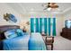 Bright main bedroom with coastal decor, tray ceilings and exterior views at 7323 Steer Blade Dr, Zephyrhills, FL 33541