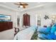Spacious main bedroom with tray ceiling, coastal decor, and ensuite bath access at 7323 Steer Blade Dr, Zephyrhills, FL 33541