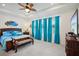 Bright bedroom with tray ceilings, a ceiling fan and blue curtains at 7323 Steer Blade Dr, Zephyrhills, FL 33541
