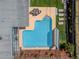 Aerial view of a backyard featuring a sparkling pool, lounging area, dining set, and well-maintained landscaping at 7530 85Th Ln, Seminole, FL 33777