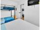 Bedroom featuring a bunk bed, queen bed, and closet with sliding mirror doors at 7530 85Th Ln, Seminole, FL 33777