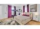 Bedroom with a full-size bed, twin-sized bunk bed with stylish purple accents at 7530 85Th Ln, Seminole, FL 33777