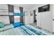 Cozy bedroom with bunk beds, modern bedding, a TV, and a view of the closet at 7530 85Th Ln, Seminole, FL 33777