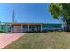 Charming home with a well-manicured lawn and colorful landscaping in a Gathering-friendly neighborhood at 7530 85Th Ln, Seminole, FL 33777