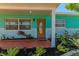 Charming front porch features landscaping with colorful plantings and an inviting entrance at 7530 85Th Ln, Seminole, FL 33777