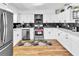 Bright kitchen featuring stainless steel appliances, white cabinets, and granite countertops at 7530 85Th Ln, Seminole, FL 33777