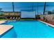 Inviting pool area with sun loungers and an outdoor movie screen, ideal for relaxation and outdoor enjoyment at 7530 85Th Ln, Seminole, FL 33777