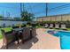 Inviting backyard pool area with stylish lounge chairs and green turf at 7530 85Th Ln, Seminole, FL 33777