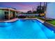 An inviting backyard pool area with outdoor seating and lush landscaping offers a perfect relaxation and entertainment space at 7530 85Th Ln, Seminole, FL 33777