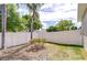 Fenced backyard with mature trees, offering a private outdoor retreat at 7824 Primula Ln, New Port Richey, FL 34654