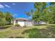 Backyard view with a privacy fence, landscaping, and well-manicured lawn at 7824 Primula Ln, New Port Richey, FL 34654