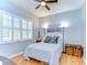 Cozy bedroom with hardwood floors, shuttered windows, and soft, natural light at 7824 Primula Ln, New Port Richey, FL 34654