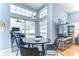 Sunlit dining area with modern table set, large windows, and sliding doors to outside at 7824 Primula Ln, New Port Richey, FL 34654