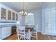 A stylish dining area with elegant cabinets and a wine fridge near a sunlit door at 7824 Primula Ln, New Port Richey, FL 34654