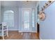 Inviting foyer with hardwood floors, a charming door curtain, and a decorative wall rack at 7824 Primula Ln, New Port Richey, FL 34654