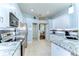 Well-lit kitchen featuring white cabinets, granite countertops, and stainless steel appliances at 7824 Primula Ln, New Port Richey, FL 34654