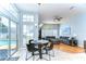 Bright living area with large windows, gray sectional, and views of the pool at 7824 Primula Ln, New Port Richey, FL 34654