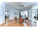 An open living space with hardwood floors, and sliding glass doors with view of a screened-in pool at 7824 Primula Ln, New Port Richey, FL 34654