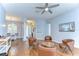 Inviting living room featuring stylish leather seating and beautiful wood flooring at 7824 Primula Ln, New Port Richey, FL 34654