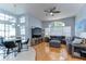 Open-concept living room with hardwood floors, a comfortable sectional, and natural light at 7824 Primula Ln, New Port Richey, FL 34654