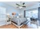 Light-filled main bedroom with ceiling fan, hardwood floors, and sliding glass doors to the pool area at 7824 Primula Ln, New Port Richey, FL 34654