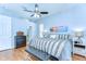 Cozy main bedroom featuring hardwood floors, ensuite bathroom, and a comfortable queen-sized bed at 7824 Primula Ln, New Port Richey, FL 34654