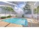 Sparkling pool with screened enclosure and brick paver deck at 7824 Primula Ln, New Port Richey, FL 34654