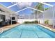 Sparkling screened-in pool with brick paver deck, perfect for relaxing and entertaining outdoors at 7824 Primula Ln, New Port Richey, FL 34654