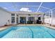 This refreshing pool is surrounded by a brick paver deck and a covered patio at 7824 Primula Ln, New Port Richey, FL 34654