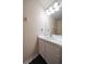 Neutral bathroom featuring a white single sink vanity and a well-lit mirror, offering a clean and functional space at 8103 Tar Hollow Dr, Gibsonton, FL 33534