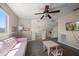 Spacious bonus room with plush seating, a cozy atmosphere, and a view of the staircase and backyard at 8103 Tar Hollow Dr, Gibsonton, FL 33534
