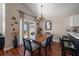 Bright dining area featuring a wood table, contemporary chandelier, and access to outdoor space at 8103 Tar Hollow Dr, Gibsonton, FL 33534