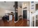 Inviting entryway open to the kitchen, wood floors, staircase, and black front door at 8103 Tar Hollow Dr, Gibsonton, FL 33534
