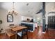 Modern kitchen featuring white cabinets, stainless steel appliances, a center island, and a dining area at 8103 Tar Hollow Dr, Gibsonton, FL 33534