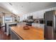 Bright kitchen with white cabinets, stainless steel appliances, and an island overlooking the backyard at 8103 Tar Hollow Dr, Gibsonton, FL 33534